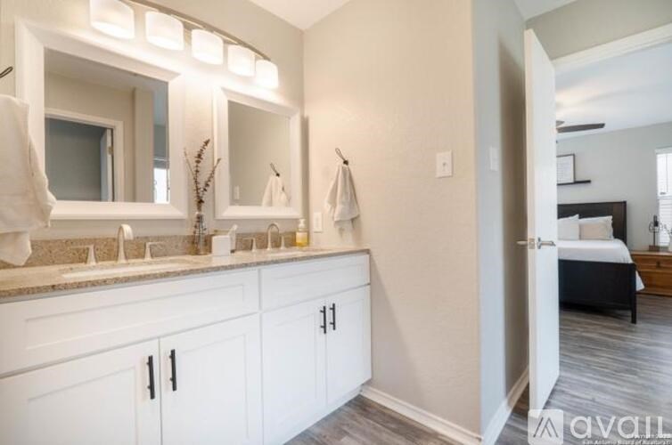 A bathroom with a vanity and a mirror above it.