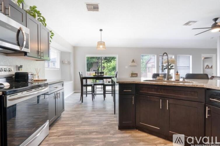 A modern kitchen with dark wood cabinets and a center island.