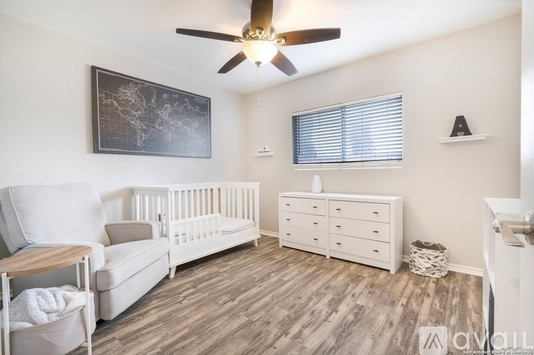 A baby room with a white crib and a world map on the wall.