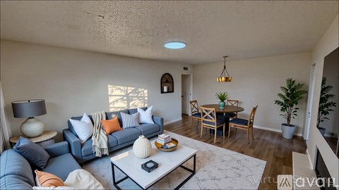 A living room with a blue couch and a coffee table.