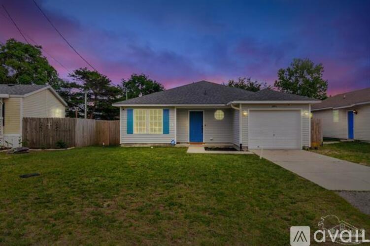 A house with a blue door is for sale.