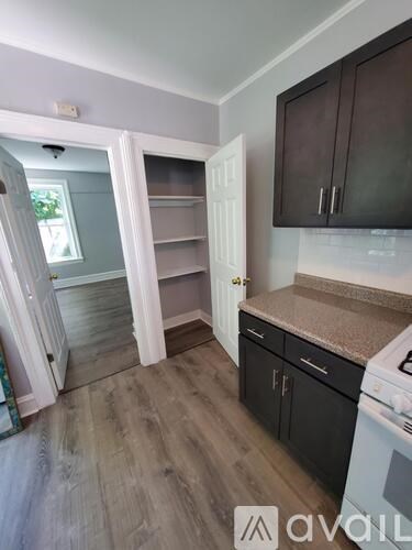 A kitchen with a white oven and black cabinets.