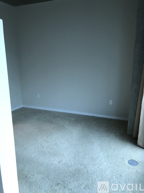 A room with a carpeted floor and a small hole in the center.