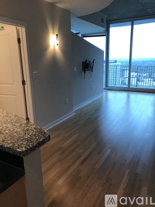 A room with wooden floors and a marble countertop.