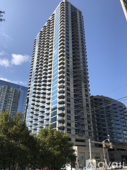 A tall building with many windows is in the foreground.