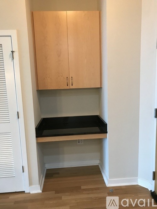 A kitchen with wooden cabinets and a white door.