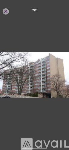 A tall building with multiple windows and balconies.