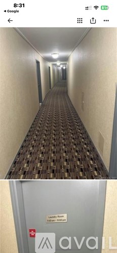 A long corridor with a metal box on the wall.