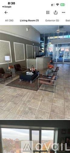 A living room with a couch, chairs, and a coffee table.