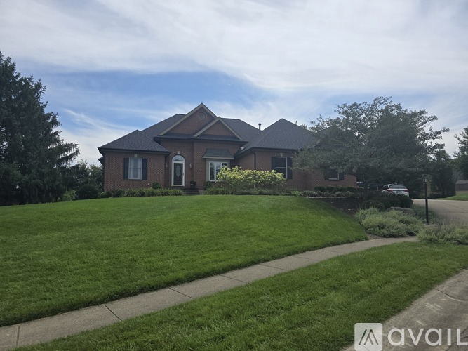 A house with a well-maintained lawn in front.
