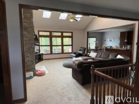 A living room with a couch and a ceiling fan.