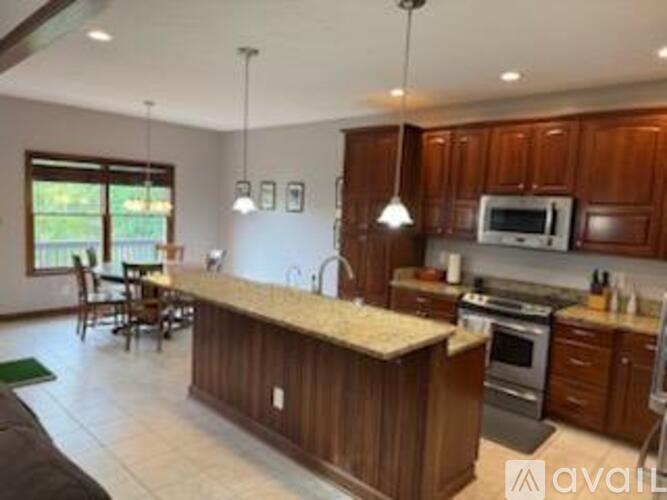 A kitchen with wooden cabinets and a granite countertop.