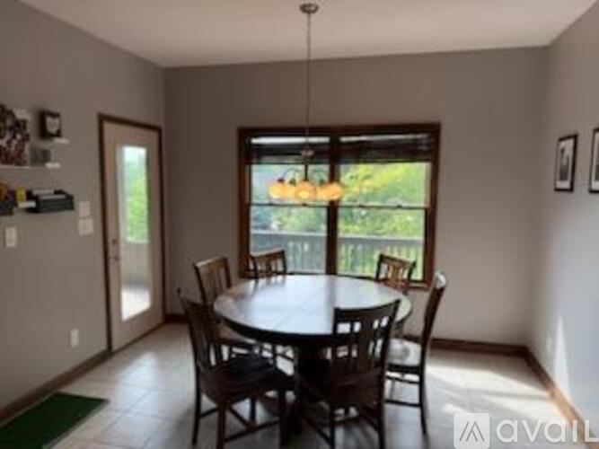 A dining room with a table and chairs.