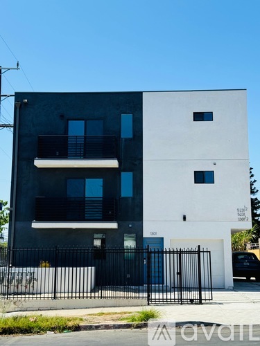 A modern two-story building with a black and white exterior.