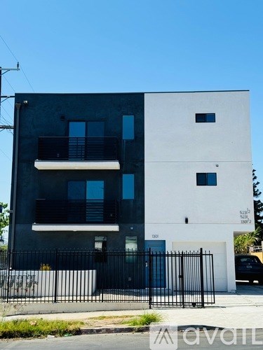 A modern two-story building with a black and white exterior.