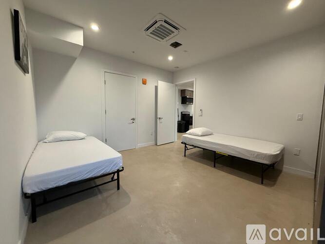A bedroom with a bed and a bench in it.