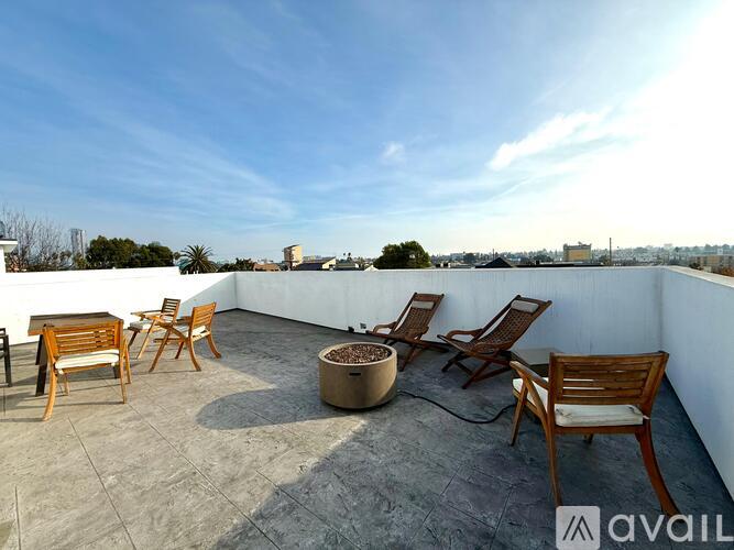 A patio with chairs and a table is available for rent.