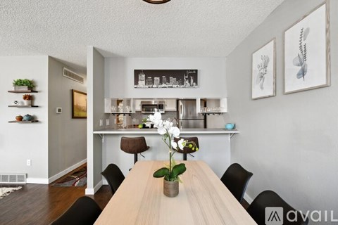 A kitchen with a table in the middle of it.