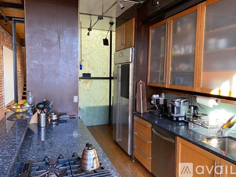 A kitchen with a stove top oven and a refrigerator.