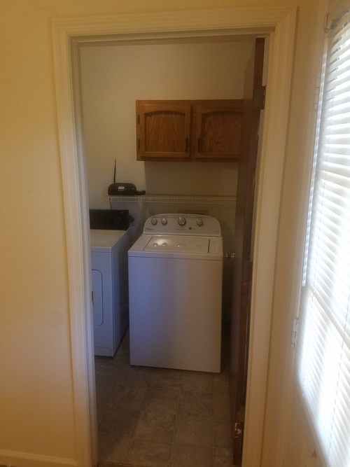 A small laundry room with a washer and dryer.