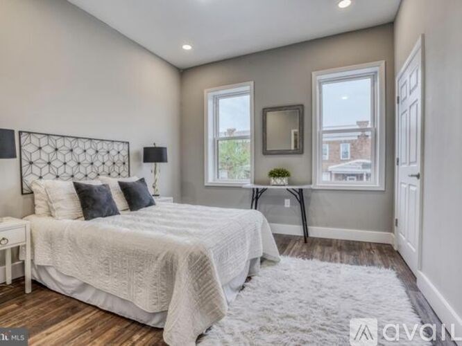 A bedroom with a large bed and a window.