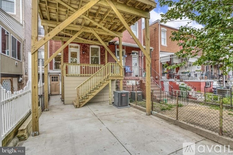 A wooden deck with a staircase leading to a building.