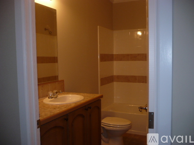 A bathroom with a toilet, sink, and bathtub.