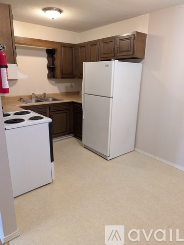 A kitchen with a white fridge and a white stove.