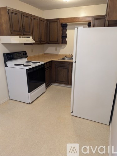 A kitchen with a white fridge and a white stove.