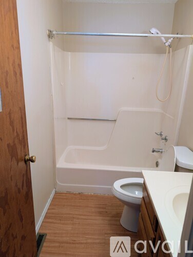 A bathroom with a toilet, sink, and bathtub.