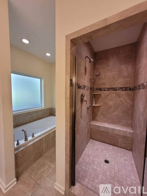 A bathroom with a tub and a walk in shower.