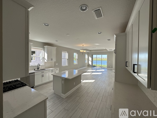 A spacious kitchen and living room with a view of the outdoors.