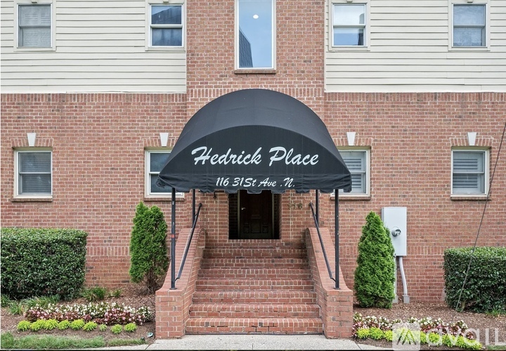 A brick building with a sign that says "Hedrick Place" above the entrance.