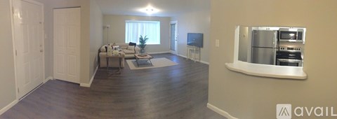 A living room with a couch and a television set.