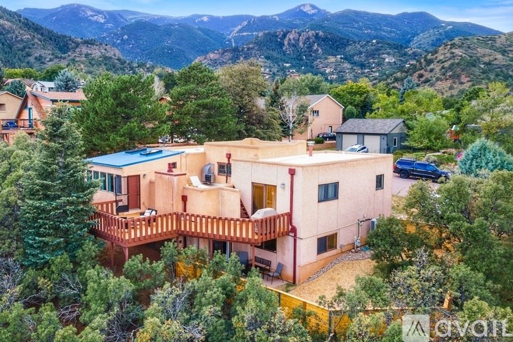 A house with a mountain view in the background.