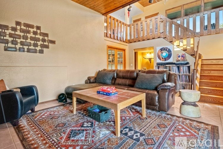 A living room with a rug and a couch.