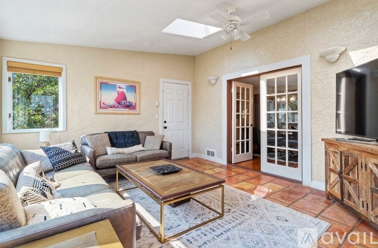 A living room with a grey couch and a wooden coffee table.