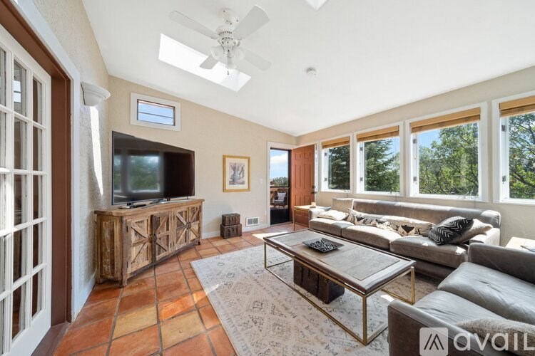 A living room with a television and a couch.