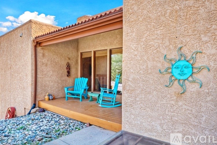 A sun-shaped decoration is on the side of a house.