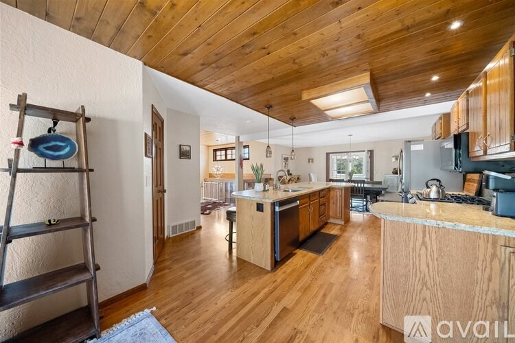 A wooden ladder is leaning against a wall in a kitchen.