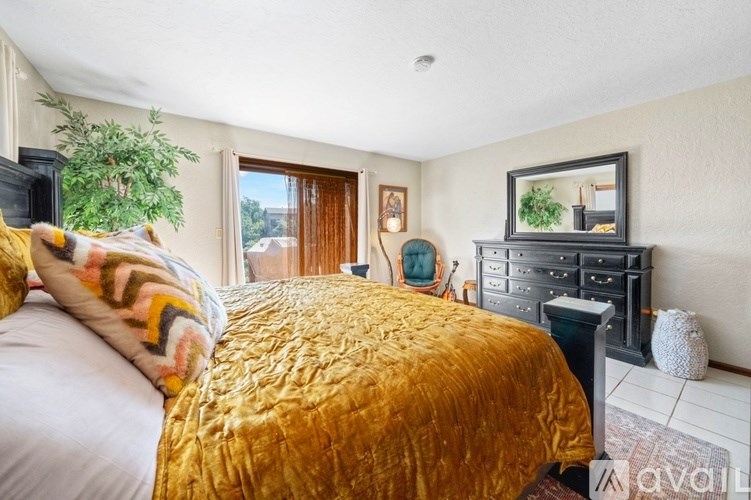 A bedroom with a large bed and a TV.
