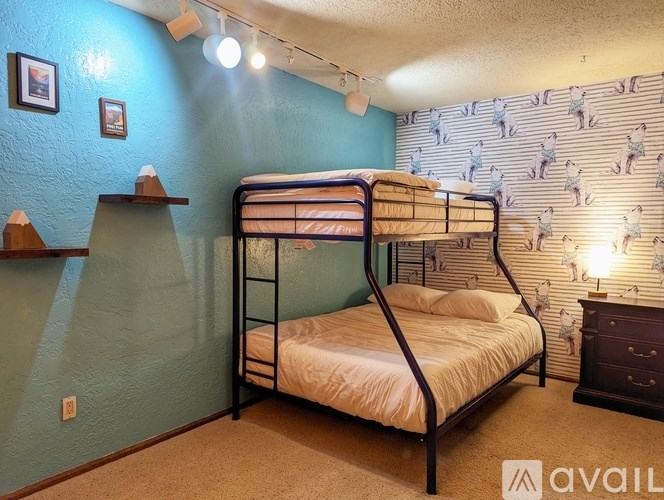 A bedroom with a bunk bed and a dresser.