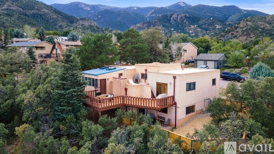 A house with a mountain view in the background is for sale.