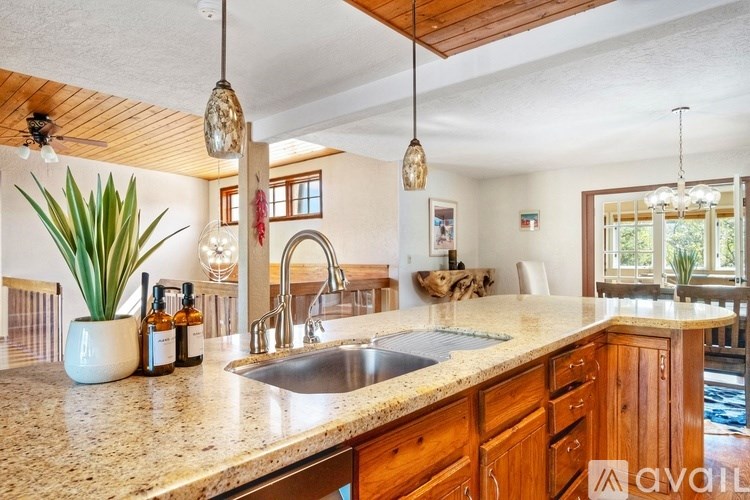 A kitchen with wooden cabinets and a granite countertop.