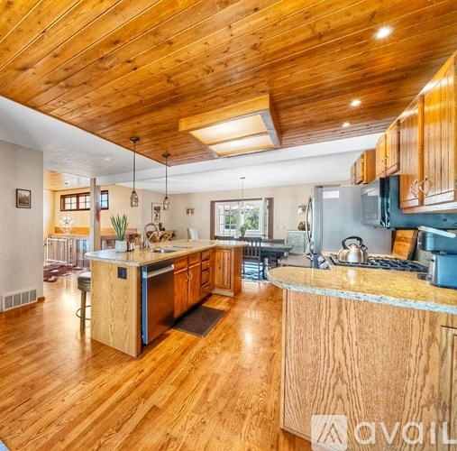 A kitchen with wooden cabinets and a central island.