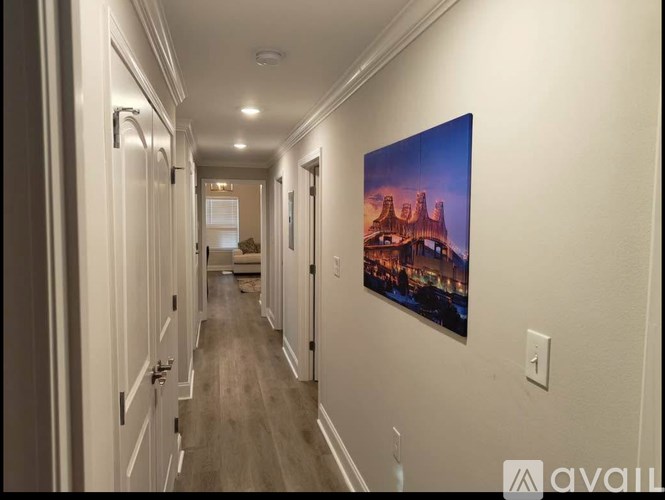 A long hallway with a painting on the wall.