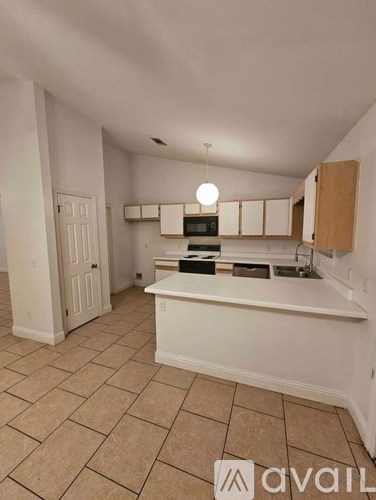 A kitchen with a white counter and brown cabinets.