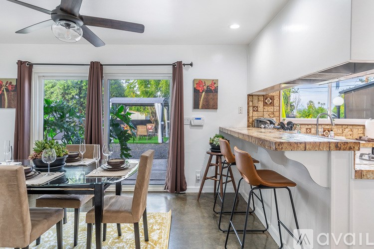 A modern dining room with a glass table and chairs.