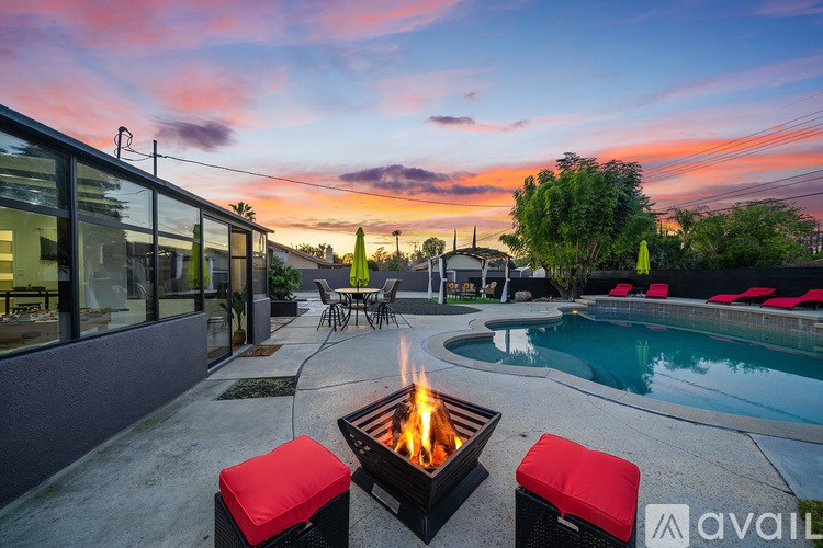 A backyard with a fire pit and a pool.