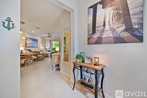A living room with a large painting of a pier on the wall.
